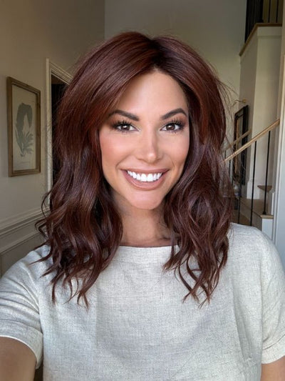 Katy C. @thewigeducator wearing BEACH WAVE MAGIC by TRESSALLURE in color 10/130R | Bright Red with Medium Brown roots