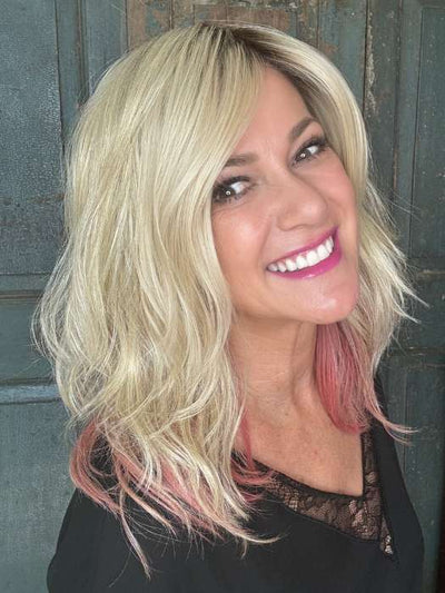 Susan Cooke @wigs_with_wisdom wearing TABU by ELLEN WILLE in color ROSE BLONDE ROOTED | Medium Dark Brown Roots that melt into a Pale Golden Blonde with a Mixture of Pink Tones Underneath with Dark Roots